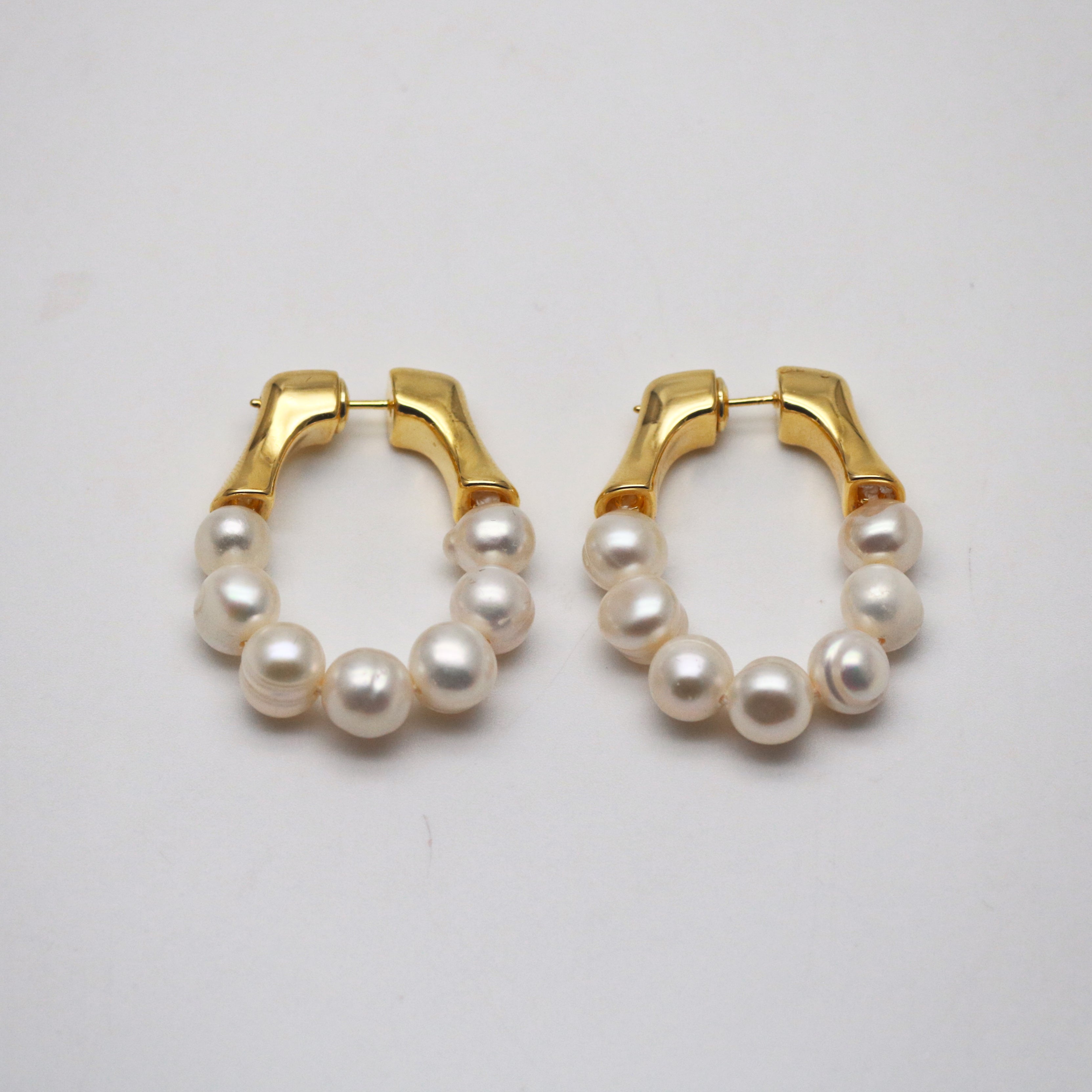 a pair of gold freshwater pearl hoops