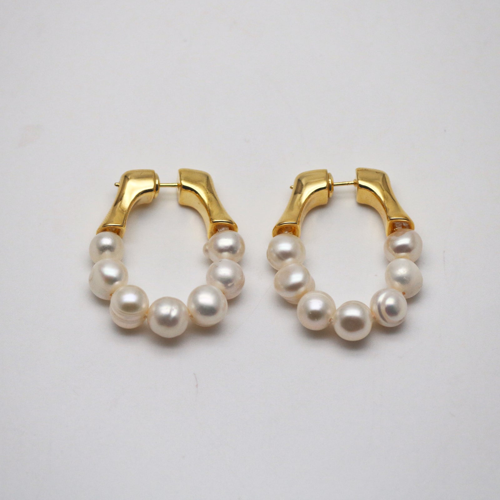 a pair of gold freshwater pearl hoops