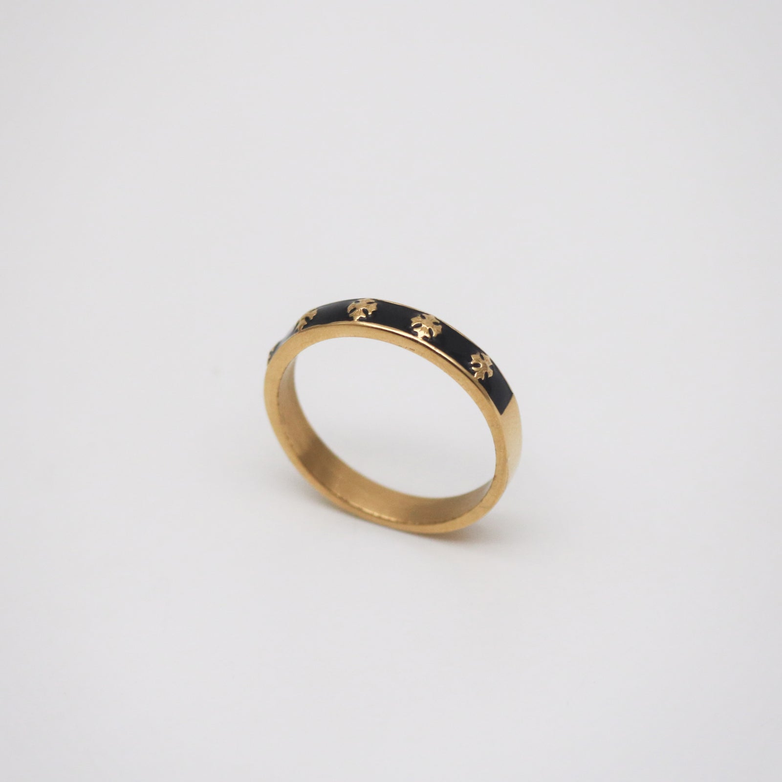thin gold band ring with black enamel and cross patterns