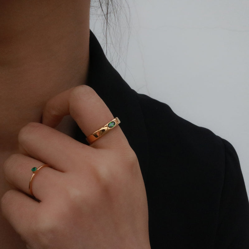band ring with green gemstone